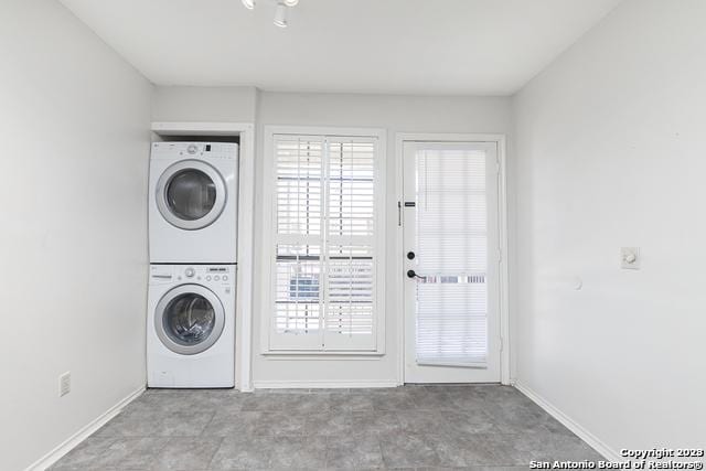 washroom featuring stacked washer and dryer