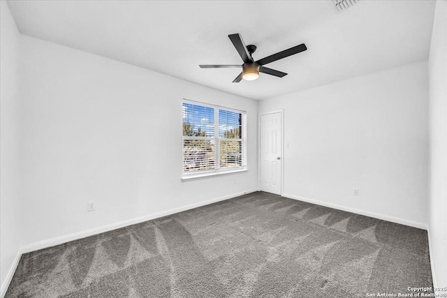 unfurnished room with ceiling fan and dark carpet