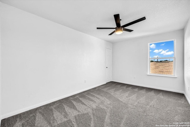 carpeted spare room with ceiling fan and a textured ceiling