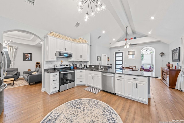 kitchen featuring white cabinetry, sink, decorative light fixtures, kitchen peninsula, and stainless steel appliances