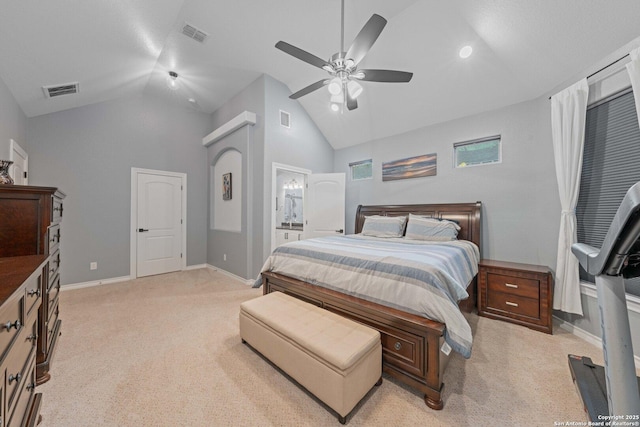 bedroom featuring ceiling fan, ensuite bathroom, high vaulted ceiling, and light carpet