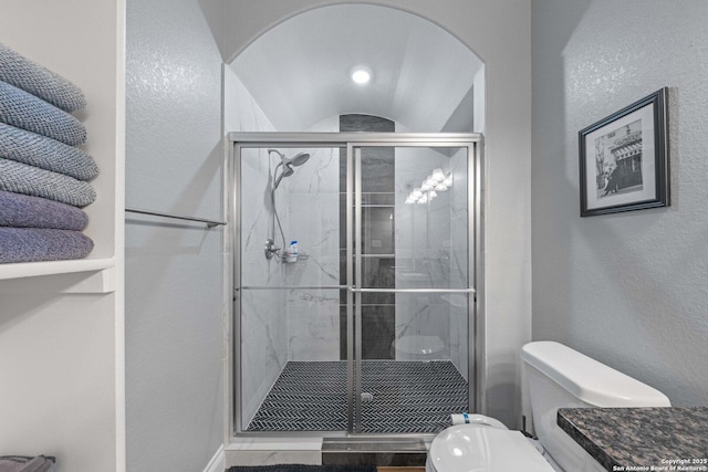 bathroom featuring toilet and an enclosed shower