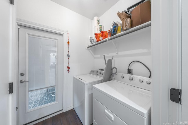 clothes washing area with dark wood-type flooring and separate washer and dryer