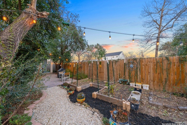 yard at dusk featuring a patio