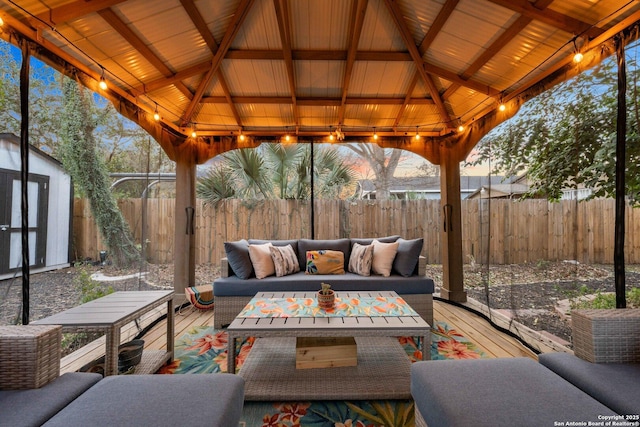 view of patio with a wooden deck, a gazebo, and outdoor lounge area