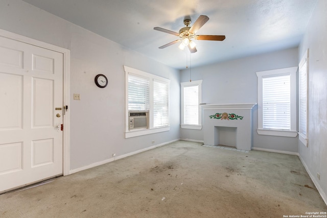 unfurnished living room featuring cooling unit and ceiling fan