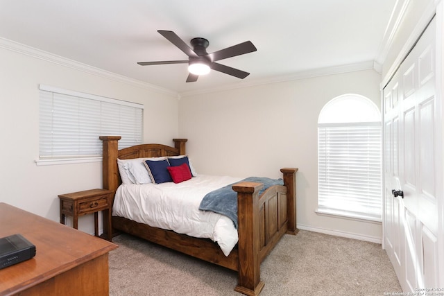 carpeted bedroom with ornamental molding and ceiling fan