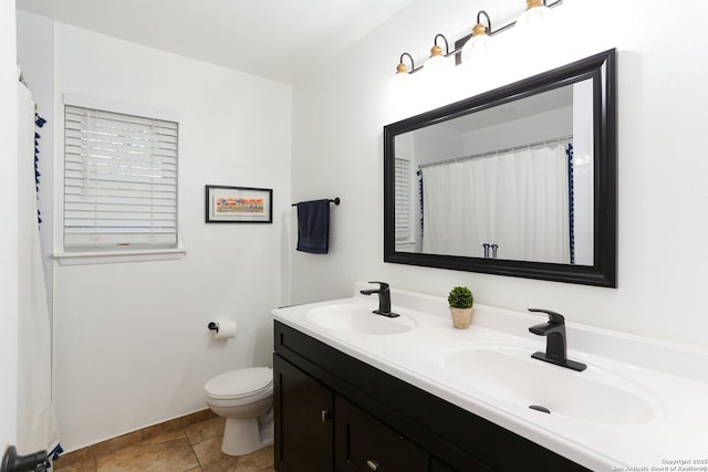 bathroom featuring tile patterned floors, toilet, and vanity