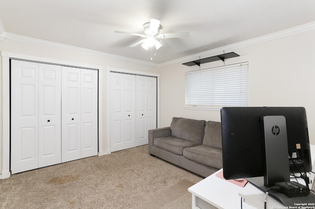 carpeted office featuring crown molding and ceiling fan