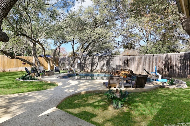 view of yard featuring a fenced in pool and a patio