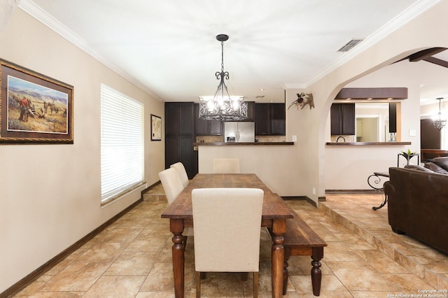 dining space with an inviting chandelier and ornamental molding