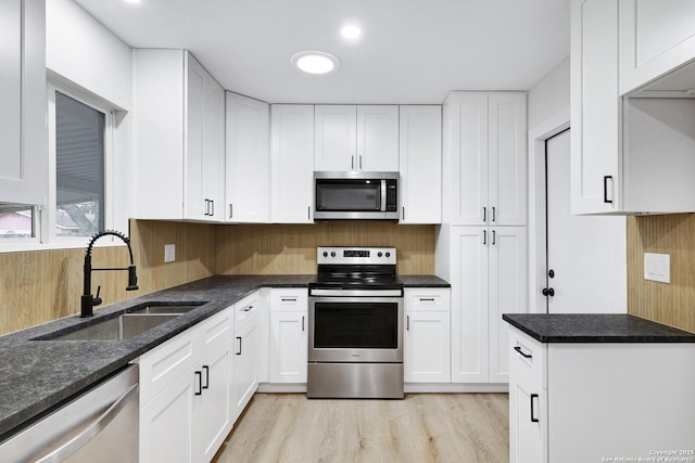 kitchen with sink, white cabinetry, and appliances with stainless steel finishes