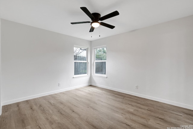 empty room with ceiling fan and light wood-type flooring