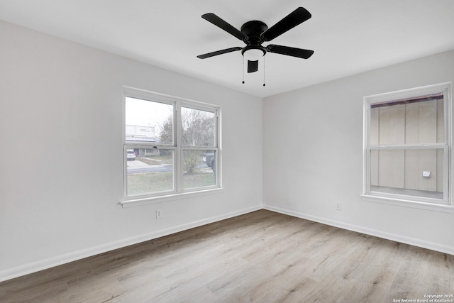 empty room featuring ceiling fan and light hardwood / wood-style floors