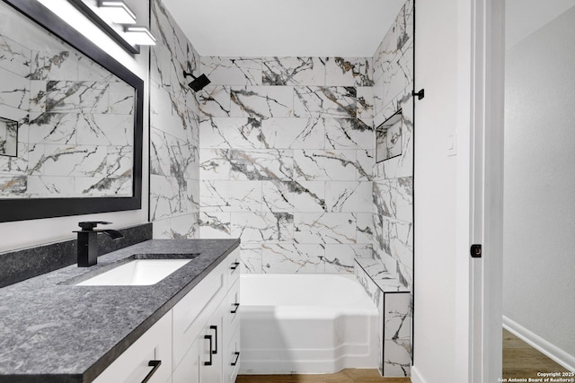 bathroom featuring vanity, bathing tub / shower combination, and wood-type flooring