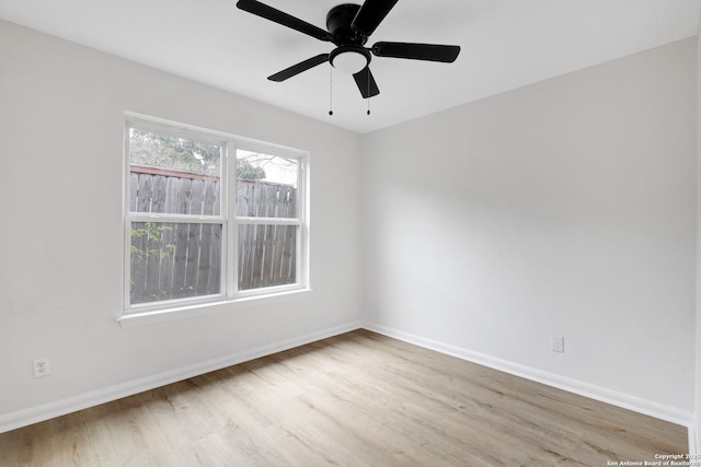 spare room featuring light hardwood / wood-style floors and ceiling fan