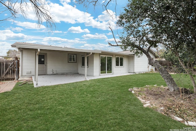 rear view of house with a patio area and a yard