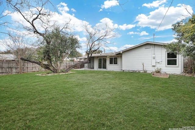 back of house with a lawn