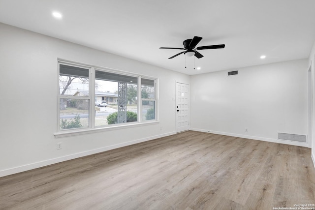 spare room featuring light hardwood / wood-style floors and ceiling fan