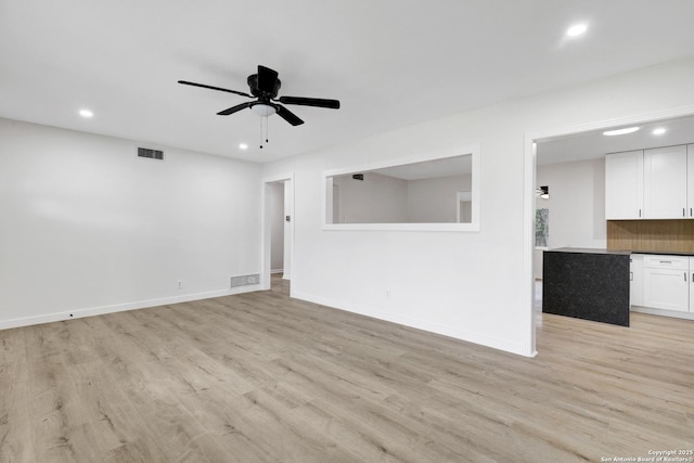 unfurnished living room with ceiling fan and light hardwood / wood-style floors