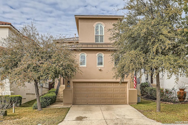 view of front of property with a garage and a front lawn