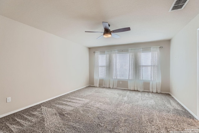 carpeted empty room featuring a textured ceiling and ceiling fan