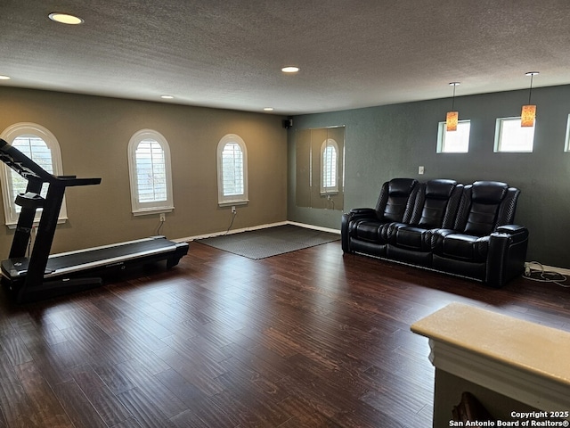 unfurnished living room with dark hardwood / wood-style floors and a textured ceiling