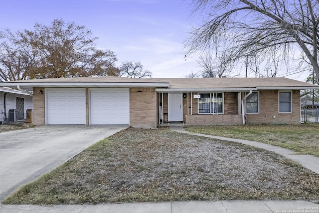 ranch-style home featuring a garage and central AC