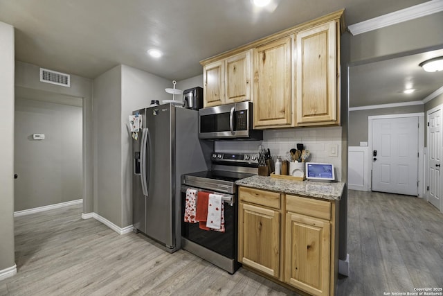 kitchen featuring crown molding, appliances with stainless steel finishes, tasteful backsplash, light stone countertops, and light hardwood / wood-style floors