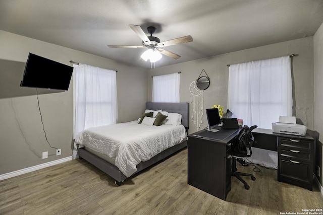 bedroom with ceiling fan and hardwood / wood-style flooring