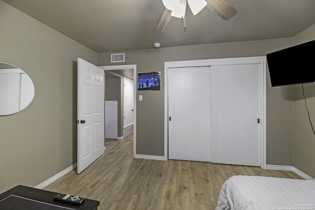 bedroom with ceiling fan, a closet, and light wood-type flooring