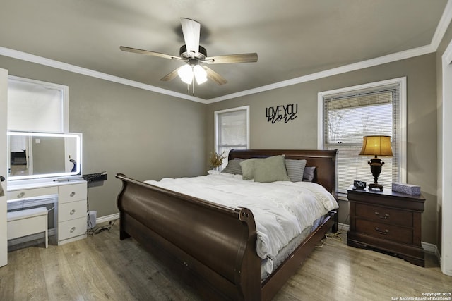 bedroom with ceiling fan, hardwood / wood-style floors, and crown molding