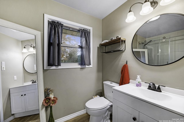 bathroom with wood-type flooring, toilet, and vanity