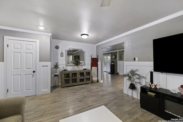 living room with hardwood / wood-style flooring and crown molding