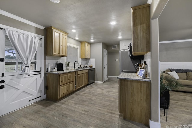 kitchen featuring light hardwood / wood-style floors, tasteful backsplash, dishwasher, sink, and ornamental molding