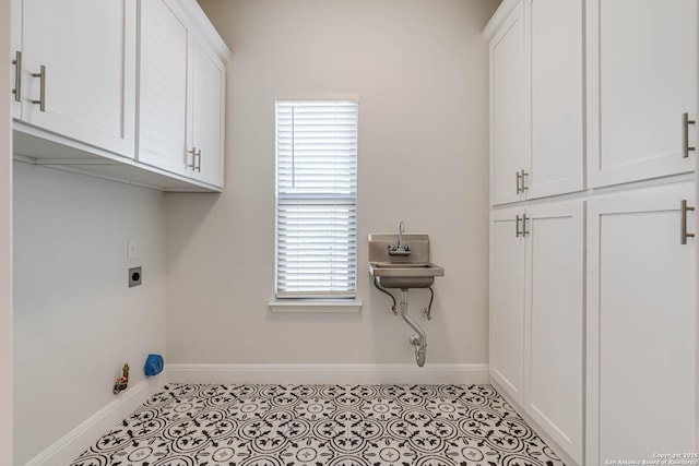 clothes washing area with cabinets, light tile patterned floors, and electric dryer hookup