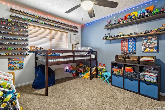 carpeted bedroom featuring ceiling fan and a textured ceiling