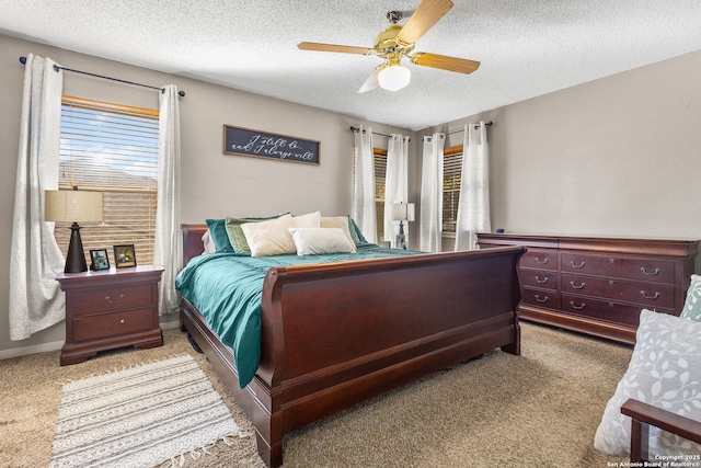 carpeted bedroom with a textured ceiling and ceiling fan