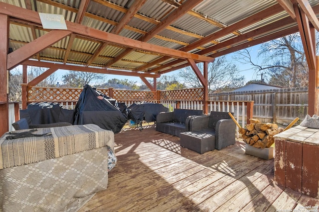 wooden terrace with an outdoor living space and grilling area