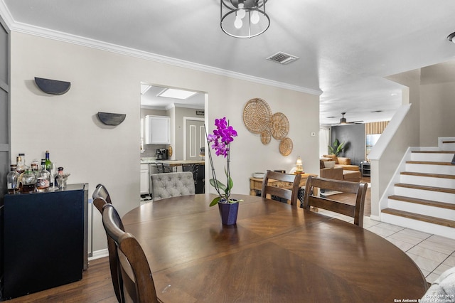 dining area featuring light tile patterned floors, ceiling fan, and ornamental molding