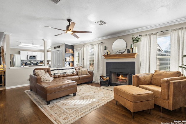 living room featuring wood-type flooring, plenty of natural light, and ornamental molding