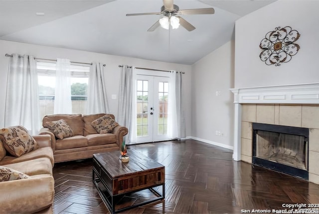 living room featuring ceiling fan, a fireplace, french doors, dark parquet flooring, and vaulted ceiling