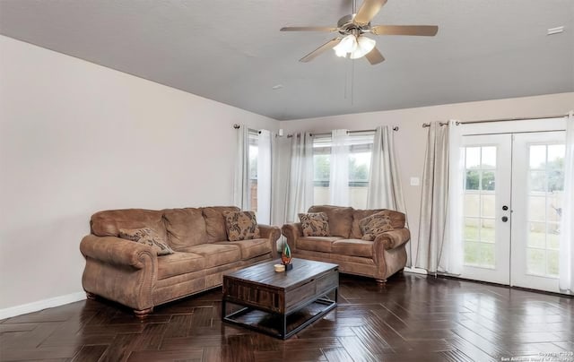 living room featuring ceiling fan, french doors, and dark parquet floors