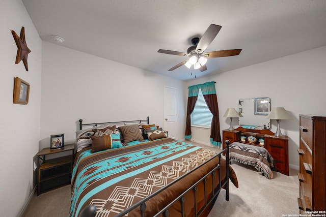 bedroom featuring light colored carpet and ceiling fan