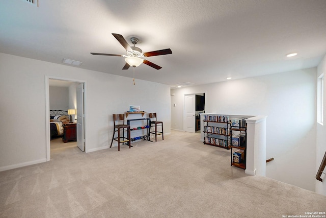 interior space with light colored carpet and ceiling fan