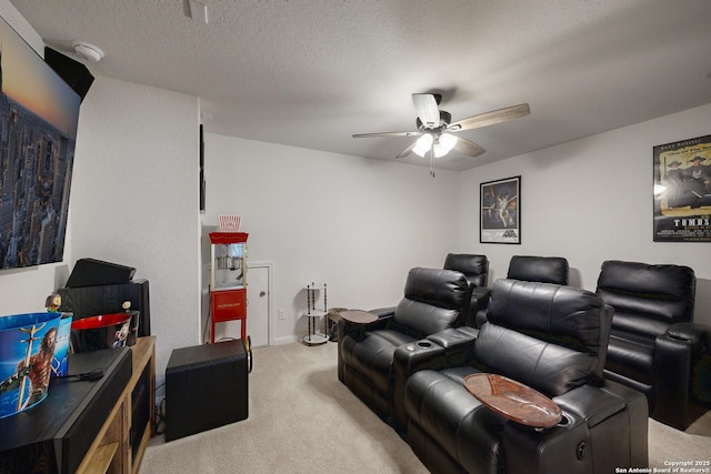 carpeted home theater with ceiling fan and a textured ceiling