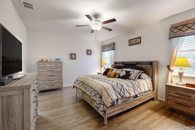 bedroom with ceiling fan and light hardwood / wood-style floors