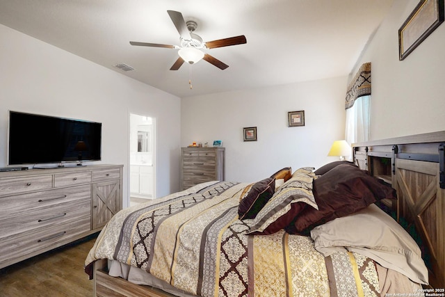 bedroom with ensuite bathroom, dark hardwood / wood-style floors, and ceiling fan