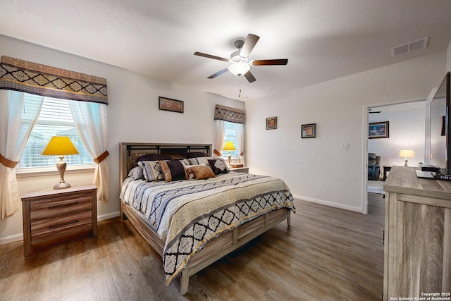 bedroom featuring ceiling fan and dark hardwood / wood-style flooring