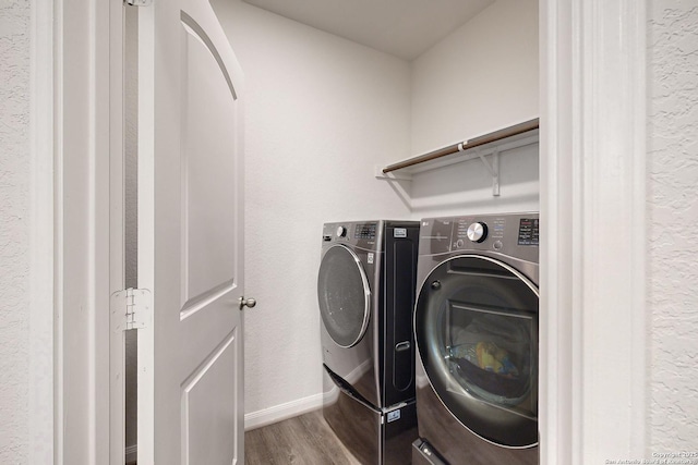 washroom featuring hardwood / wood-style flooring and independent washer and dryer